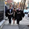 Three happy business graduates on road side